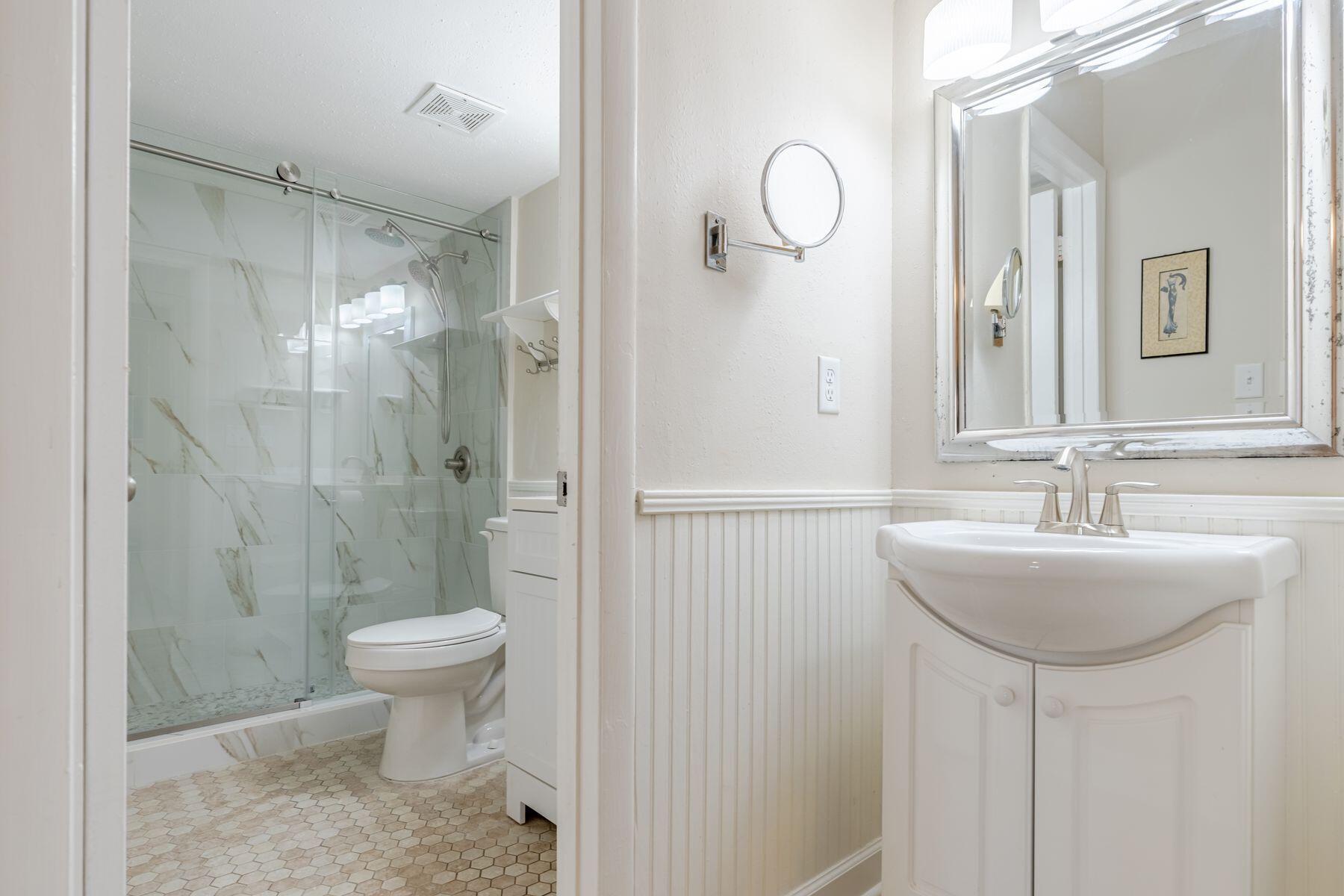 56 Sunset Bay, Unit 17B Miramar Beach, FL 32550 - Photo 16 of 30 a bathroom with a sink toilet a mirror and shower