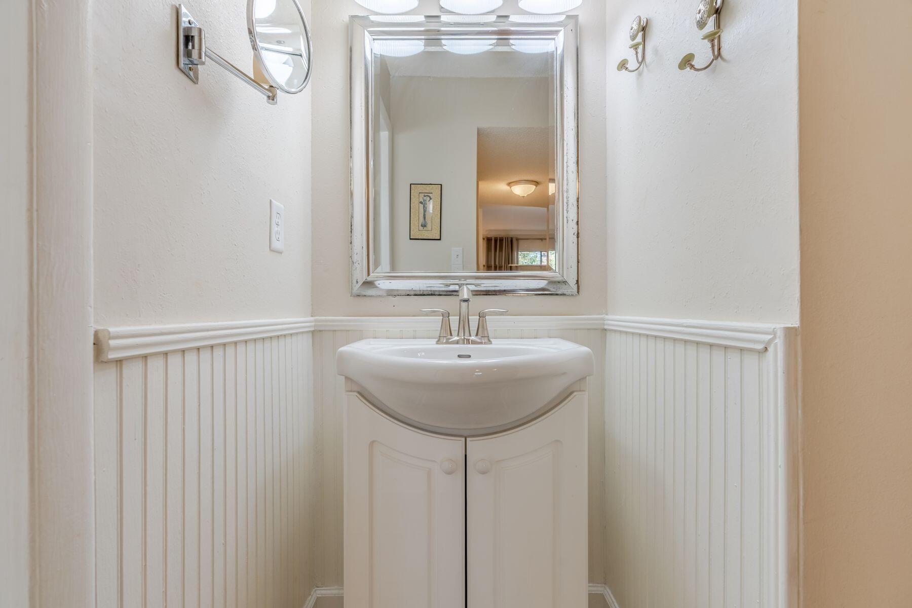 56 Sunset Bay, Unit 17B Miramar Beach, FL 32550 - Photo 18 of 30 a bathroom with a sink a mirror and a vanity