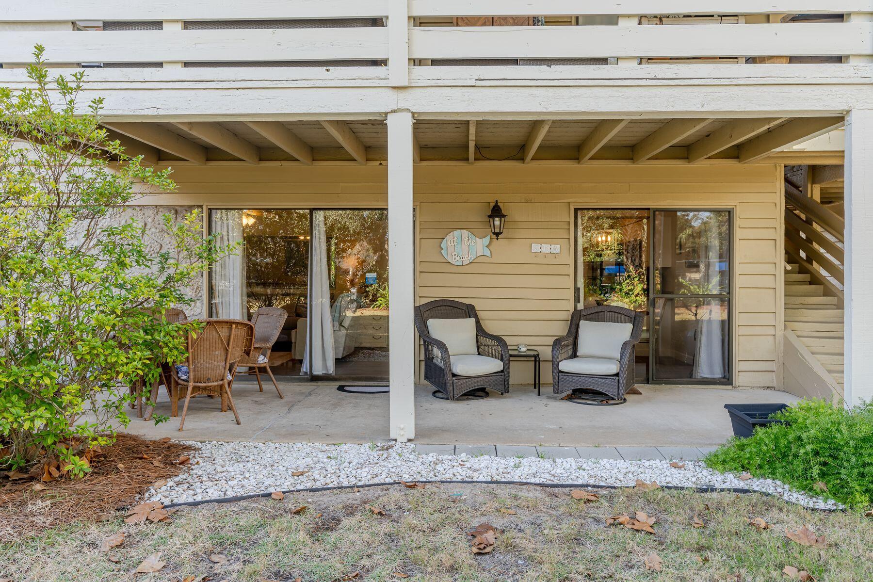 56 Sunset Bay, Unit 17B Miramar Beach, FL 32550 - Photo 20 of 30 a view of two chairs in the patio