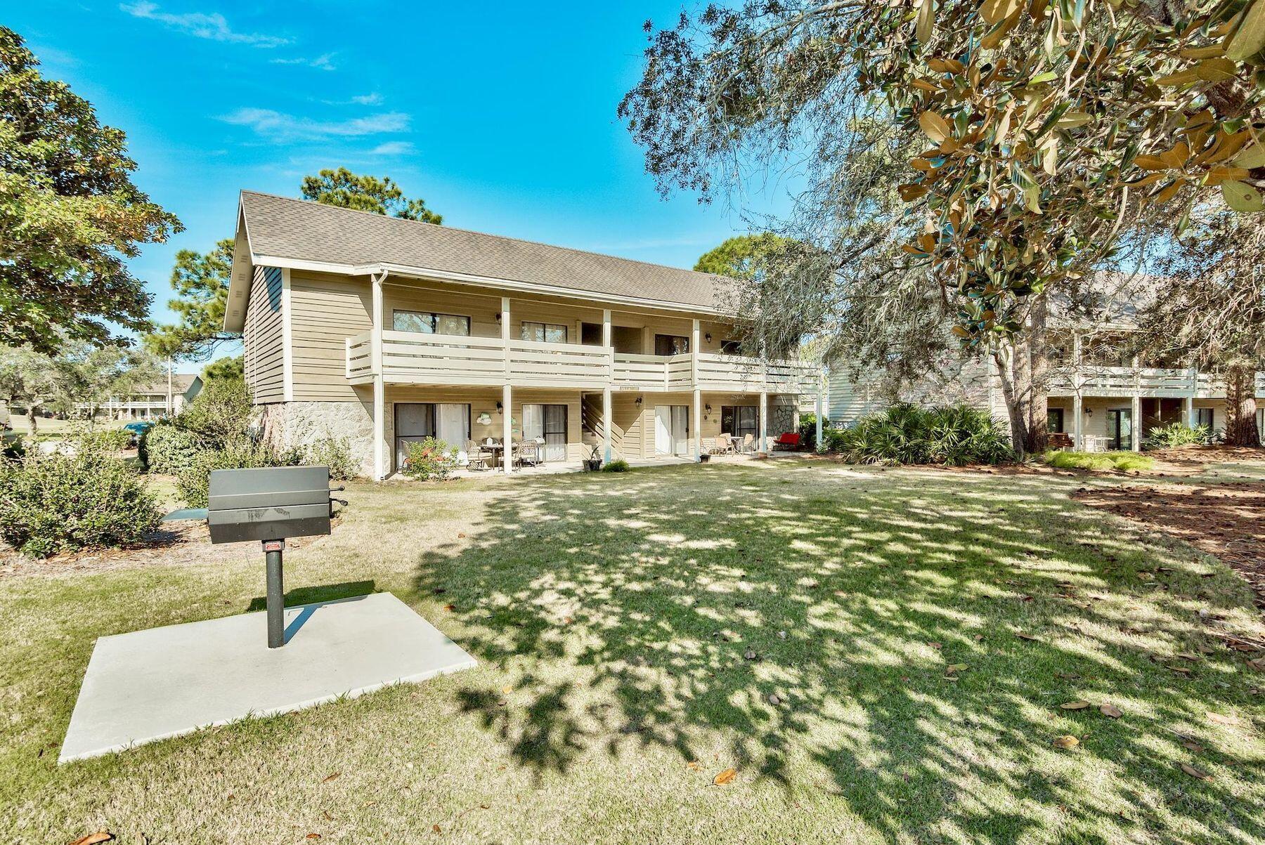 56 Sunset Bay, Unit 17B Miramar Beach, FL 32550 - Photo 21 of 30 a front view of a house with a yard