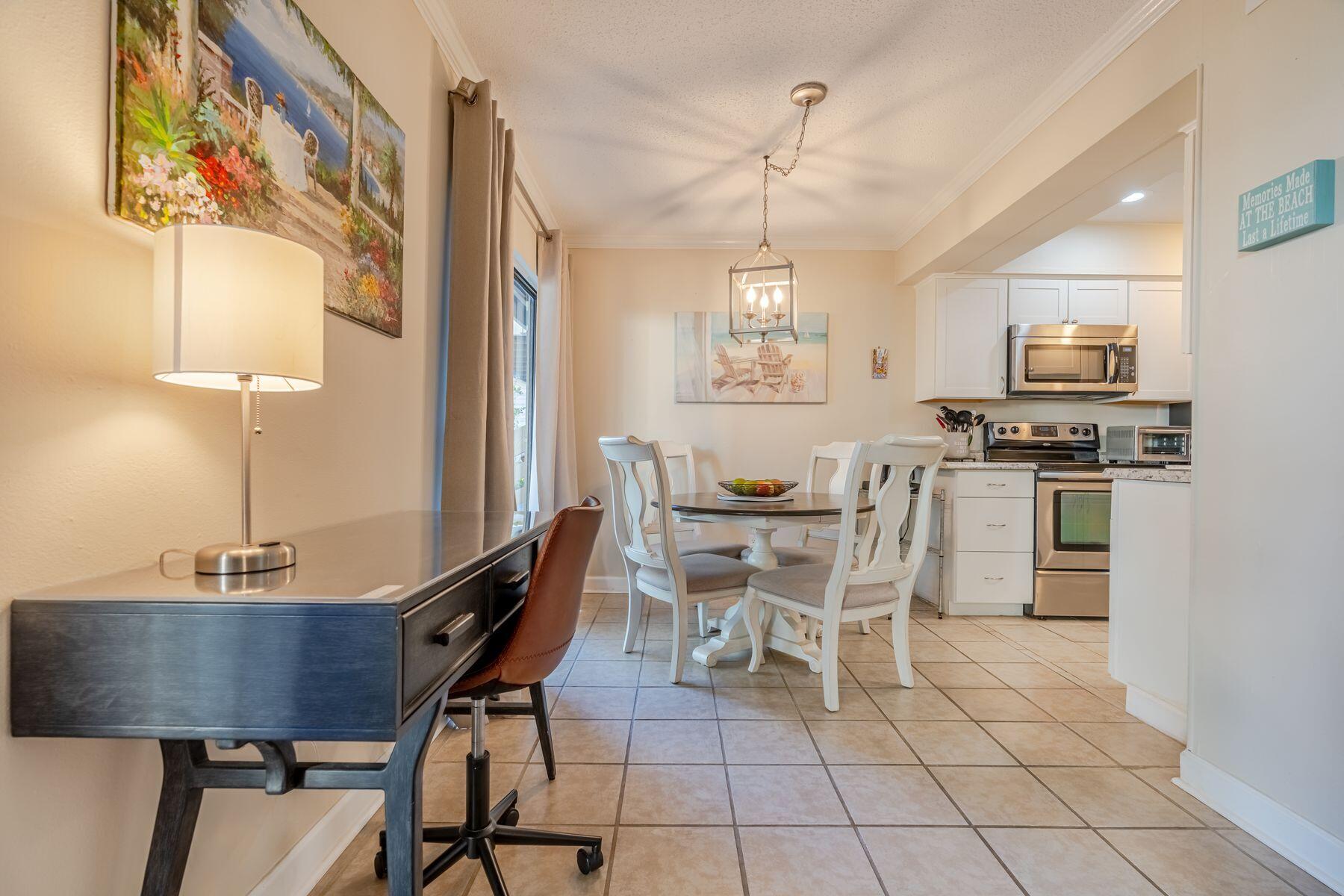 56 Sunset Bay, Unit 17B Miramar Beach, FL 32550 - Photo 5 of 30 a view of a dining room with furniture and a chandelier