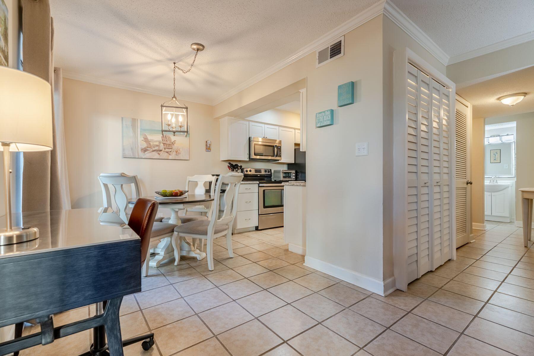 56 Sunset Bay, Unit 17B Miramar Beach, FL 32550 - Photo 6 of 30 a open kitchen with stainless steel appliances granite countertop a stove and a refrigerator