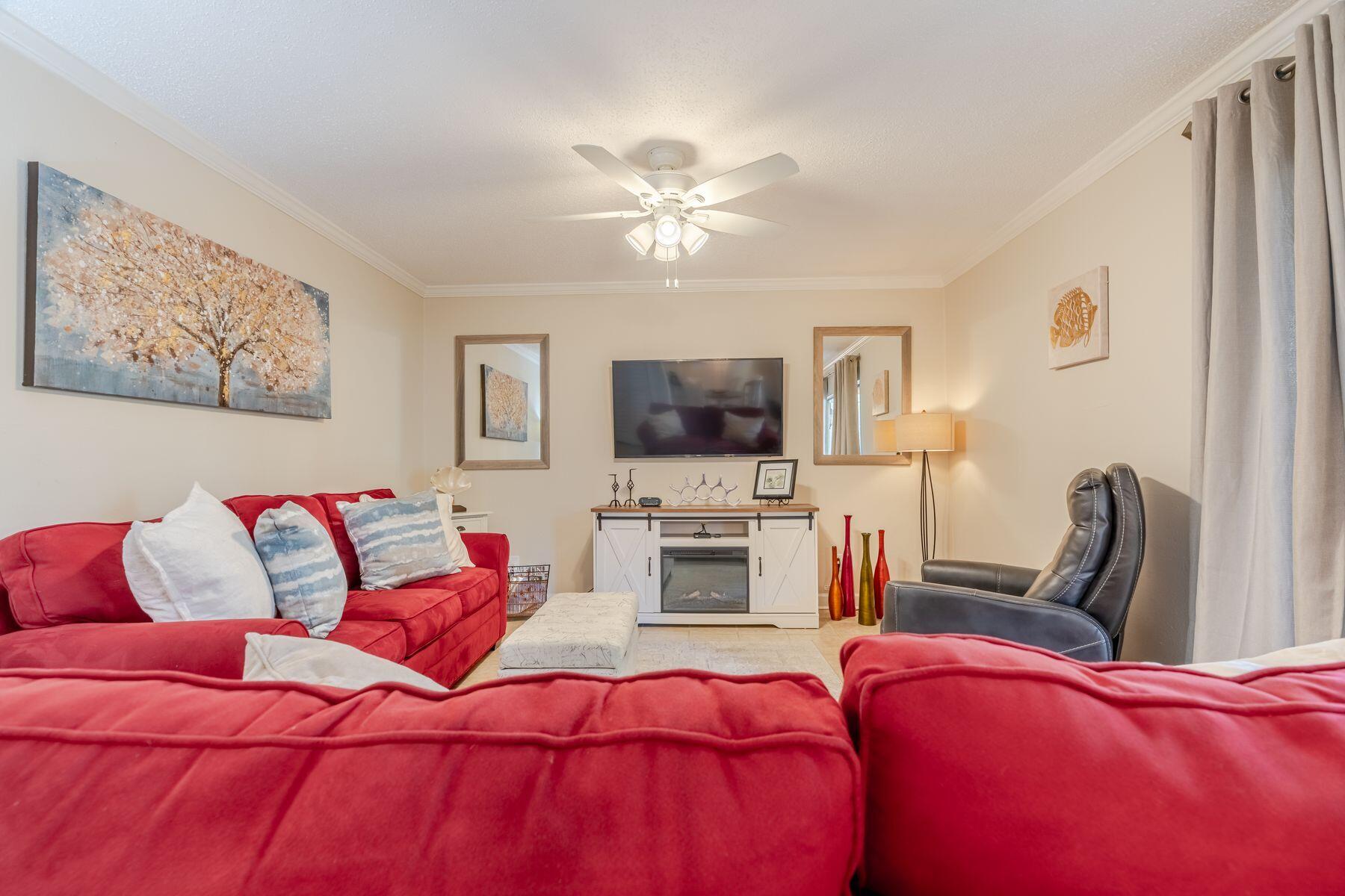 56 Sunset Bay, Unit 17B Miramar Beach, FL 32550 - Photo 7 of 30 a living room with furniture and a flat screen tv