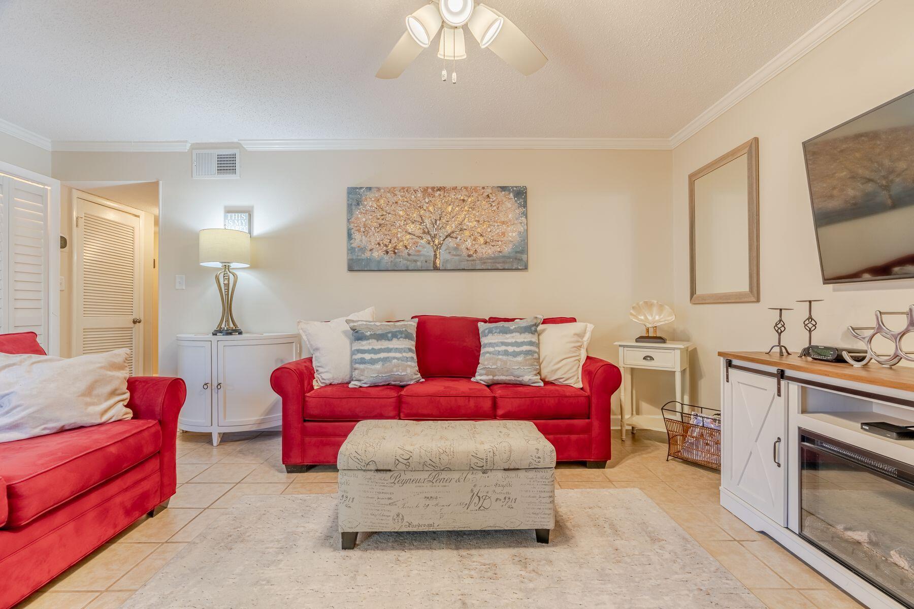 56 Sunset Bay, Unit 17B Miramar Beach, FL 32550 - Photo 8 of 30 a living room with furniture and a flat screen tv