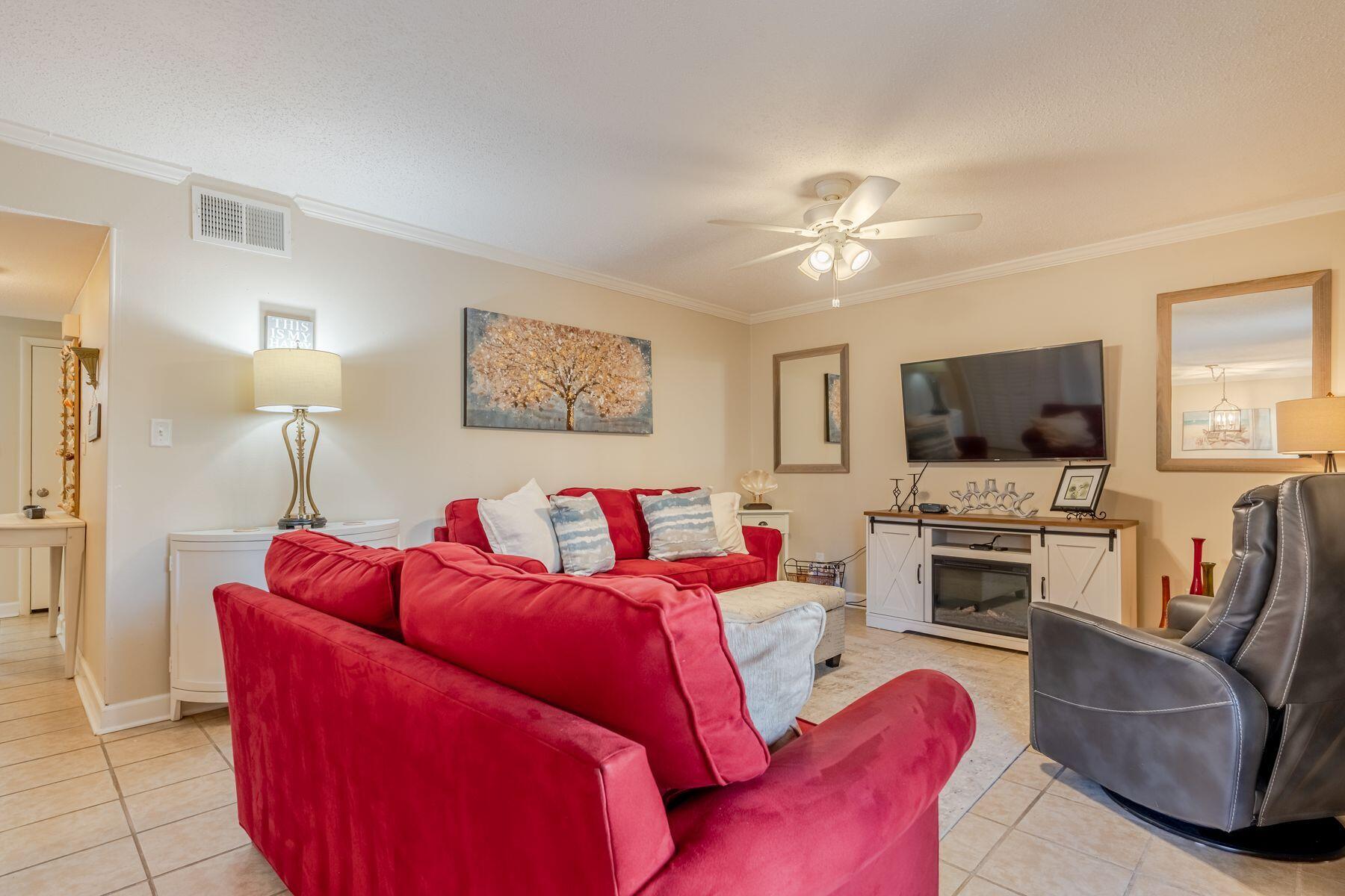 56 Sunset Bay, Unit 17B Miramar Beach, FL 32550 - Photo 9 of 30 a living room with furniture and a flat screen tv