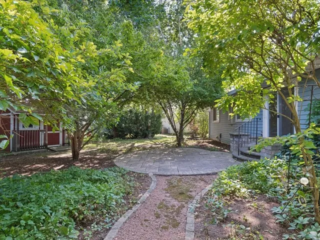 a backyard of a house with table and chairs