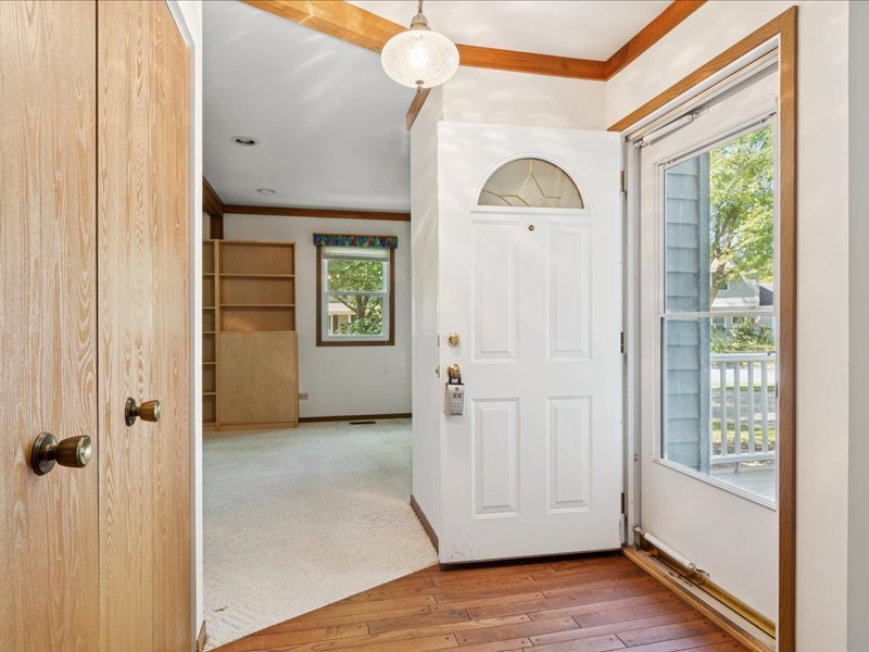1323 Auburn Avenue Naperville, IL 60565 - Photo 3 of 16 an empty room with windows wooden floor and cabinet