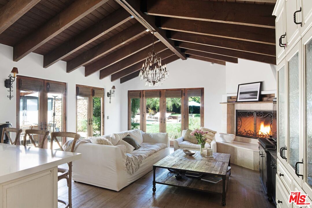 2251 Cold Canyon Road Calabasas, CA 91302 - Photo 7 of 47 a living room with furniture fireplace and a flat screen tv