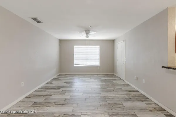 wooden floor in an empty room with a window