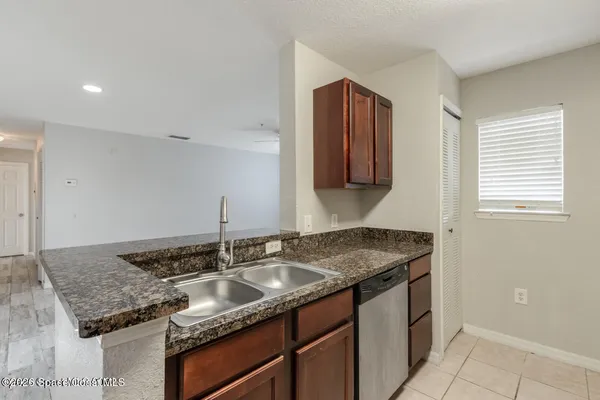 a kitchen with granite countertop a sink and a stove