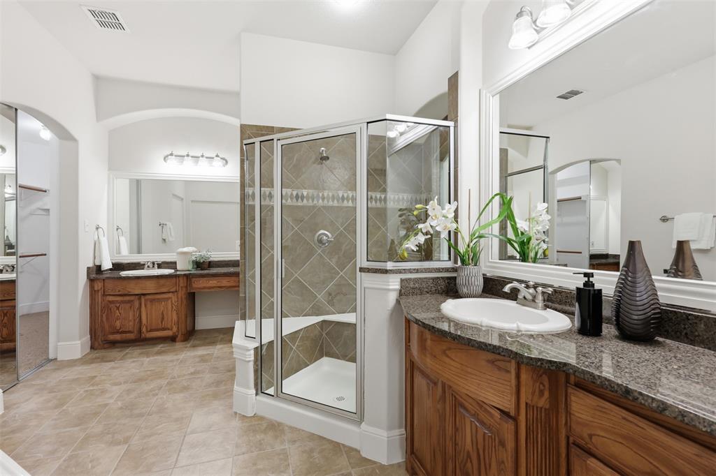2841 Meadow Ridge Drive Prosper, TX 75078 - Photo 22 of 40 a spacious bathroom with a granite countertop sink mirror and shower