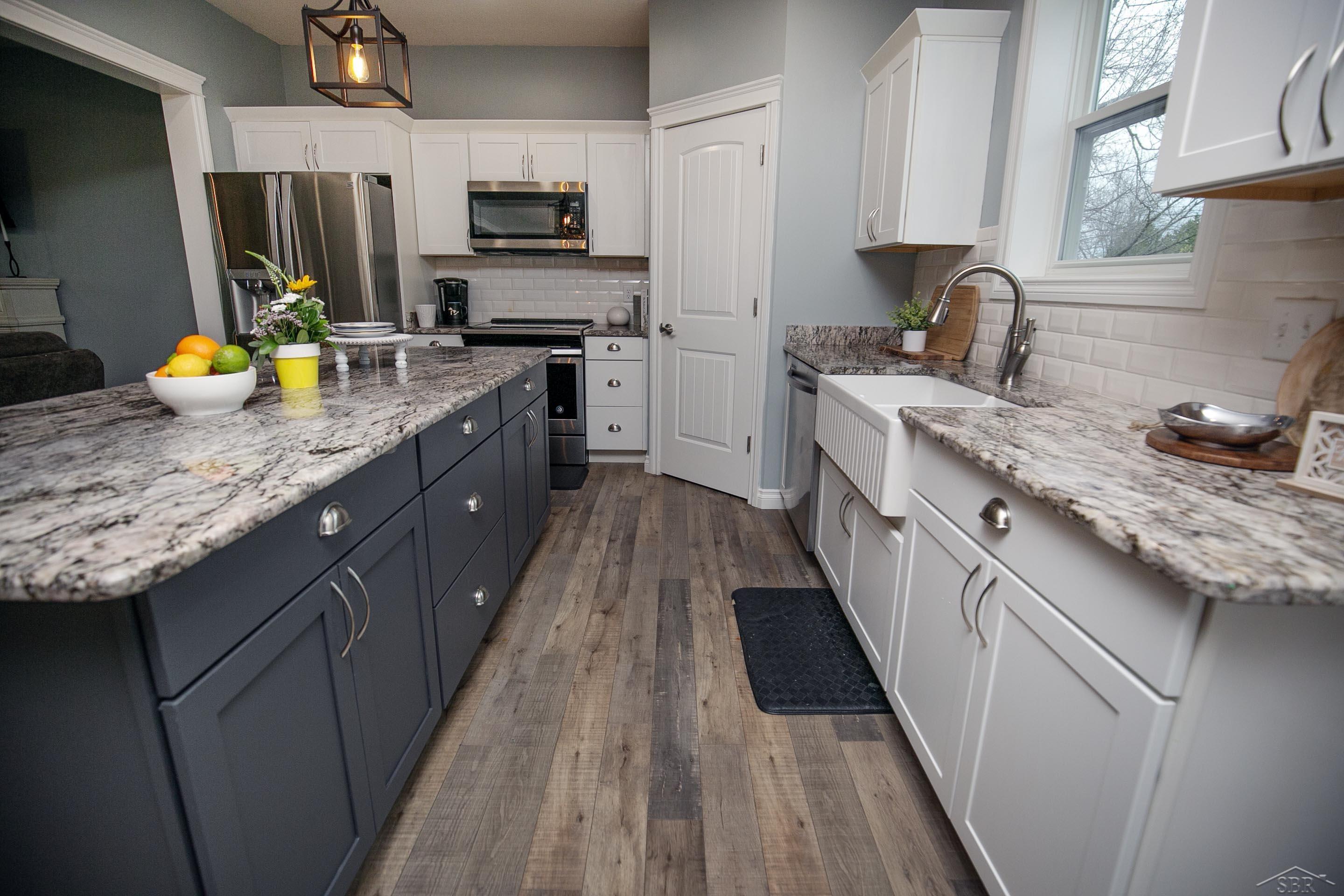 7890 Mielke Road Freeland, MI 48623 - Photo 8 of 48 Multi-tonal cabinets adding dimension to the space