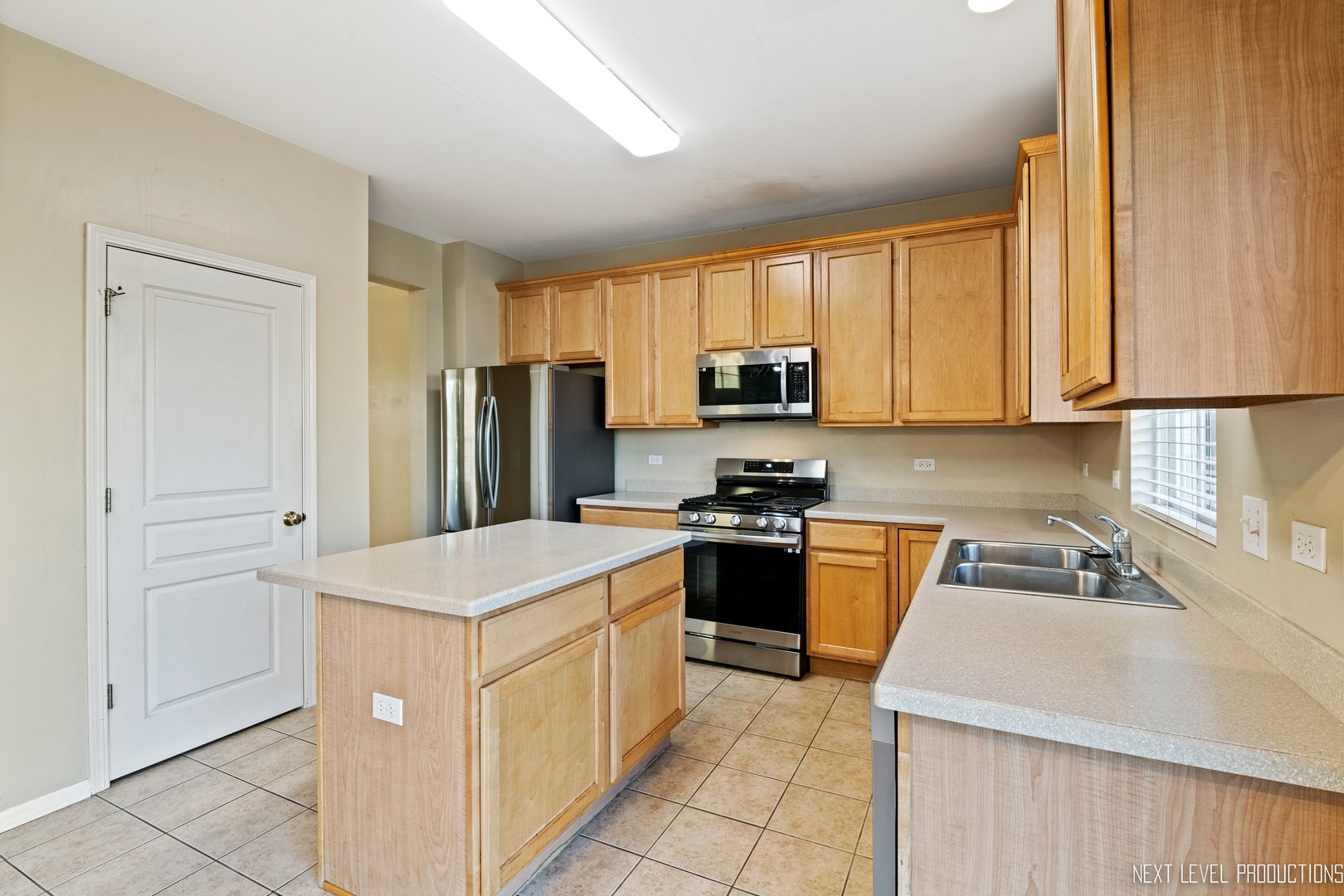 230 Tiger Street Bolingbrook, IL 60490 - Photo 12 of 27 a kitchen with a sink stove and refrigerator