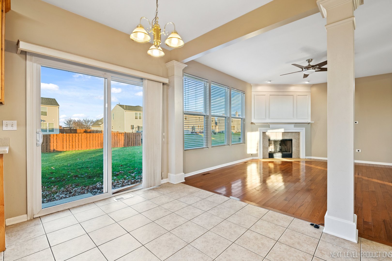 230 Tiger Street Bolingbrook, IL 60490 - Photo 13 of 27 a view of an empty room with window chandelier and wooden floor