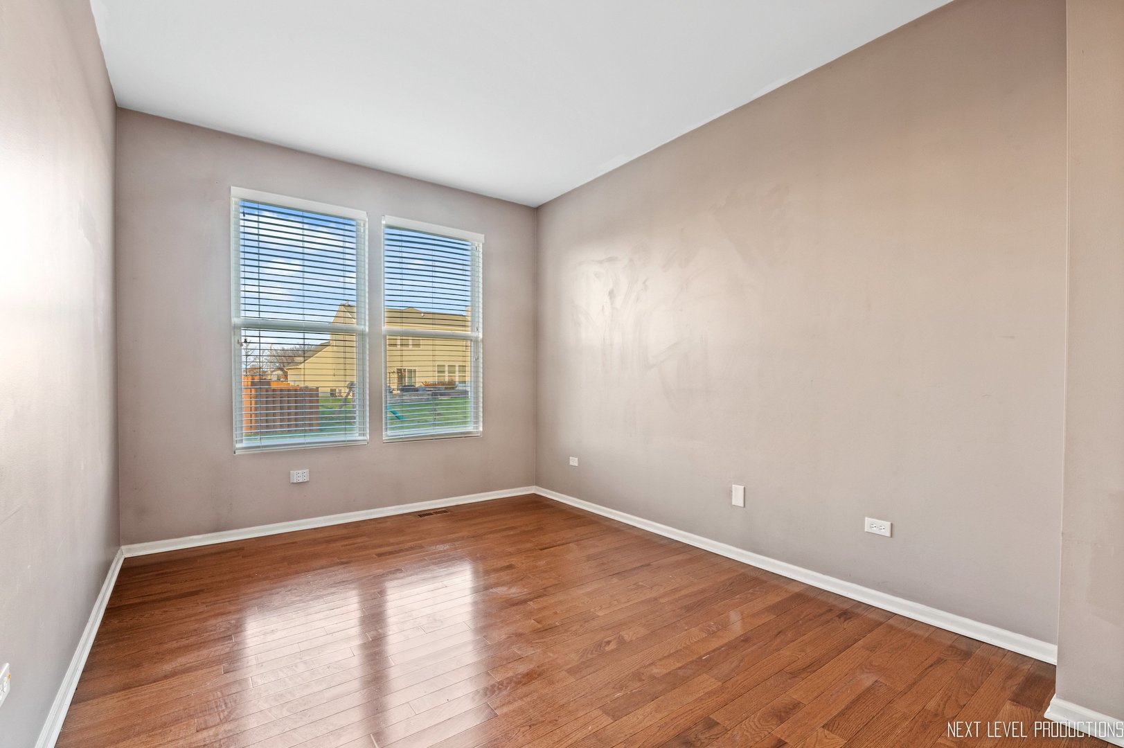 230 Tiger Street Bolingbrook, IL 60490 - Photo 14 of 27 a view of an empty room with wooden floor and a window