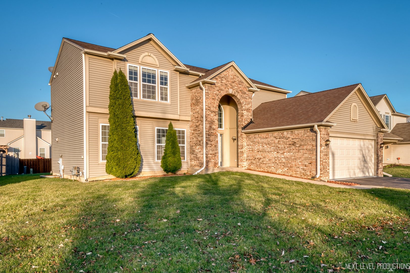 230 Tiger Street Bolingbrook, IL 60490 - Photo 2 of 27 a view of a big house with a big yard and large trees