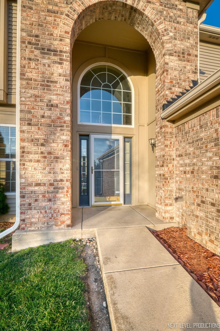 230 Tiger Street Bolingbrook, IL 60490 - Photo 3 of 27 a front view of a house with a yard