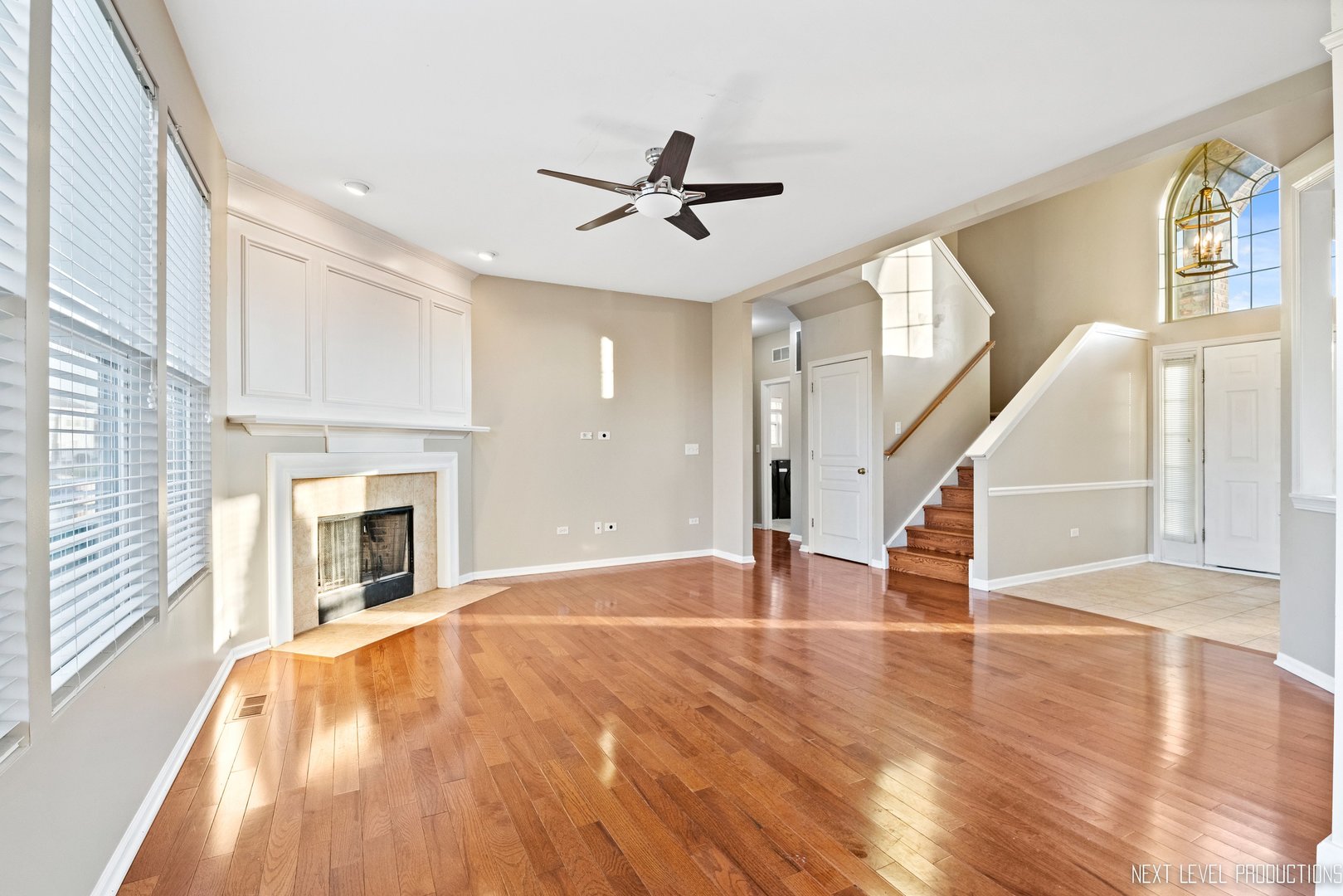 230 Tiger Street Bolingbrook, IL 60490 - Photo 7 of 27 a view of empty room with wooden floor and fireplace