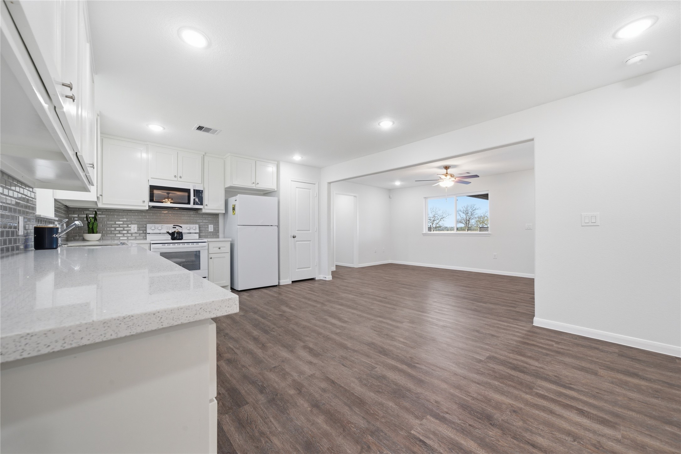 6623 County Road 4 Damon, TX 77430 - Photo 12 of 48 a view of kitchen with stainless steel appliances granite countertop a refrigerator a sink dishwasher and a oven with wooden floor
