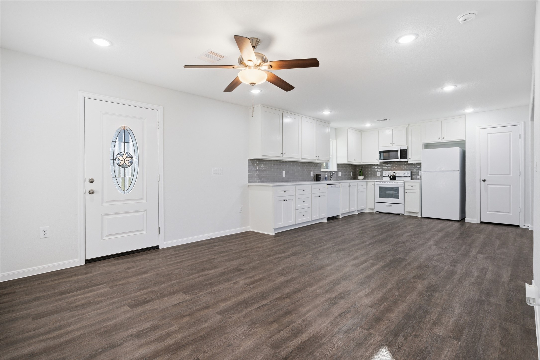 6623 County Road 4 Damon, TX 77430 - Photo 13 of 48 a view of a kitchen with a refrigerator a ceiling fan and wooden floor
