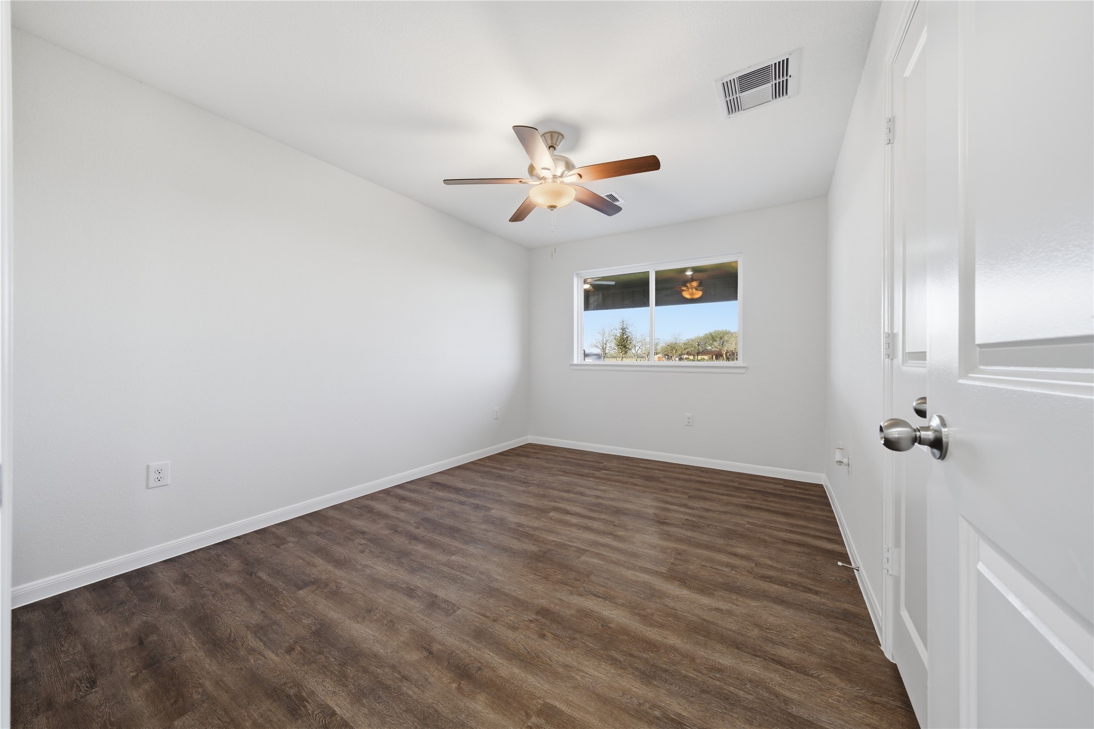 6623 County Road 4 Damon, TX 77430 - Photo 14 of 48 an empty room with windows and fan