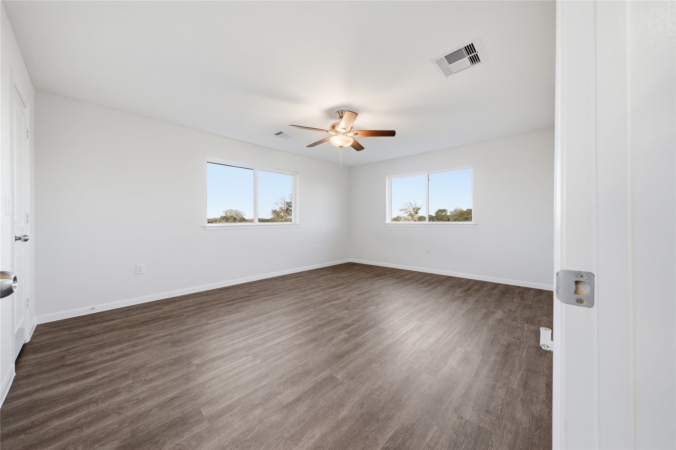 6623 County Road 4 Damon, TX 77430 - Photo 16 of 48 an empty room with wooden floor and windows