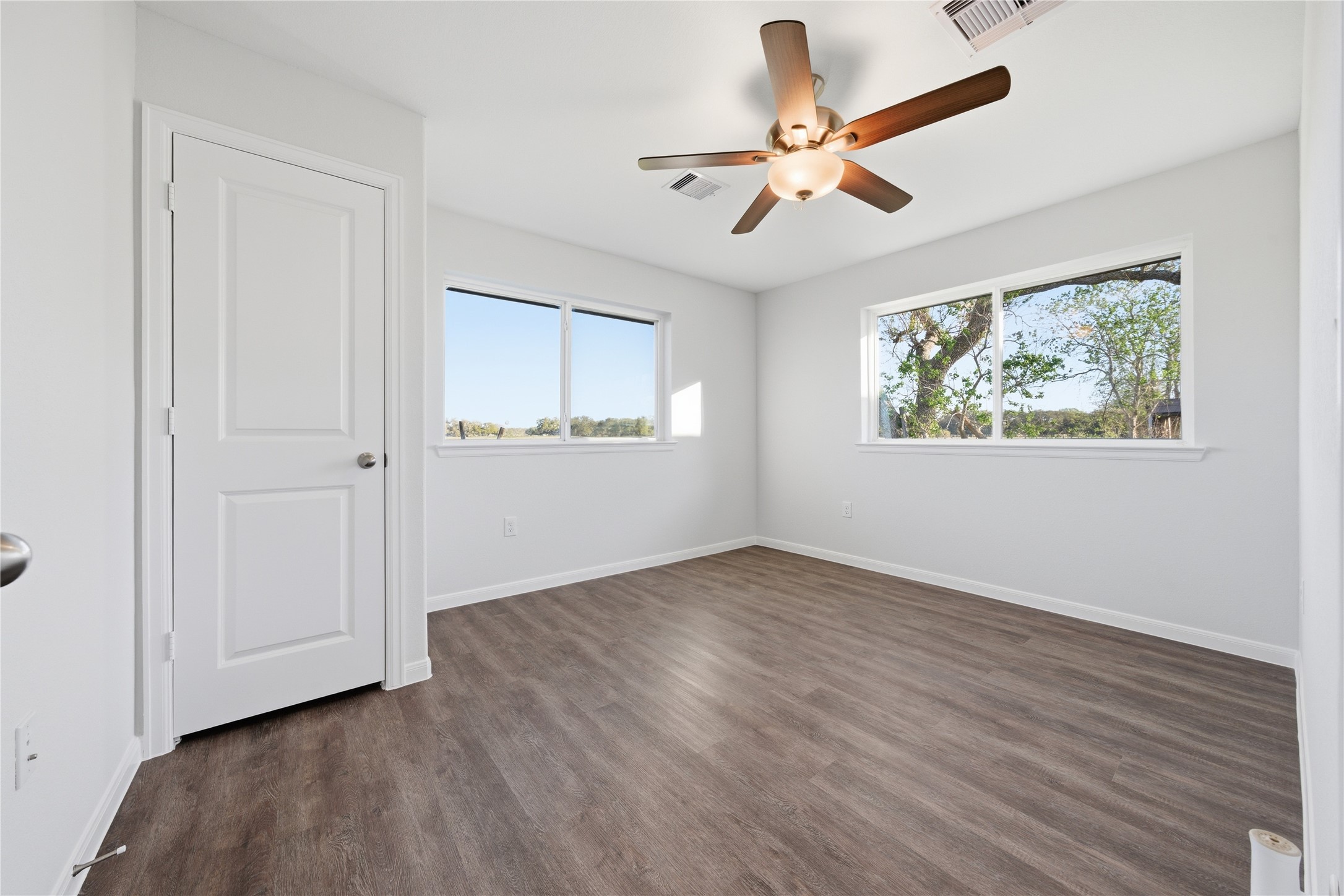6623 County Road 4 Damon, TX 77430 - Photo 18 of 48 a view of an empty room with wooden floor and a window