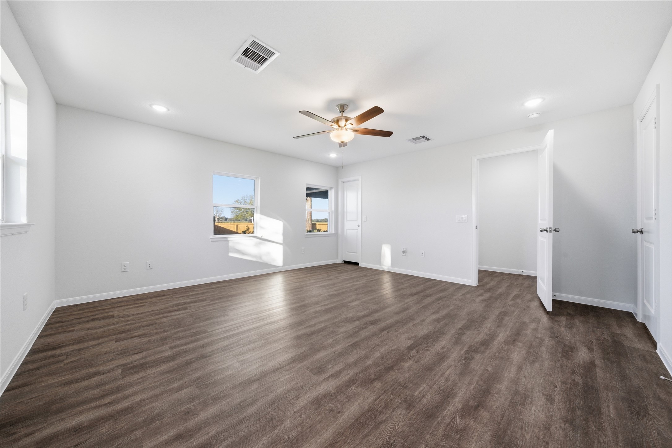 6623 County Road 4 Damon, TX 77430 - Photo 21 of 48 an empty room with wooden floor and a ceiling fan