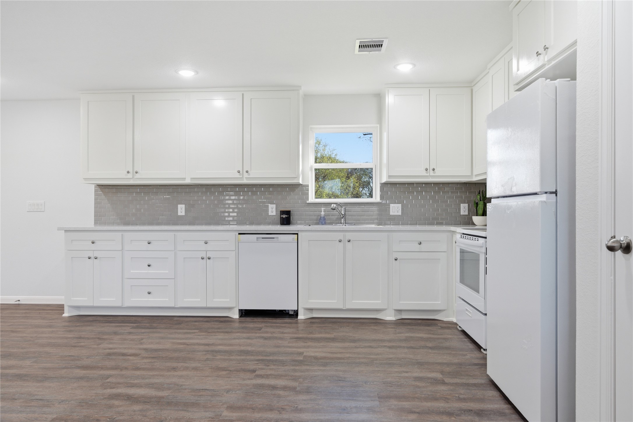 6623 County Road 4 Damon, TX 77430 - Photo 9 of 48 a kitchen with granite countertop white cabinets white stainless steel appliances and sink