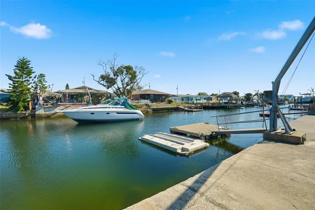 a view of a lake with boats and trees in the background