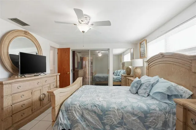 a bedroom with a bed and cabinets