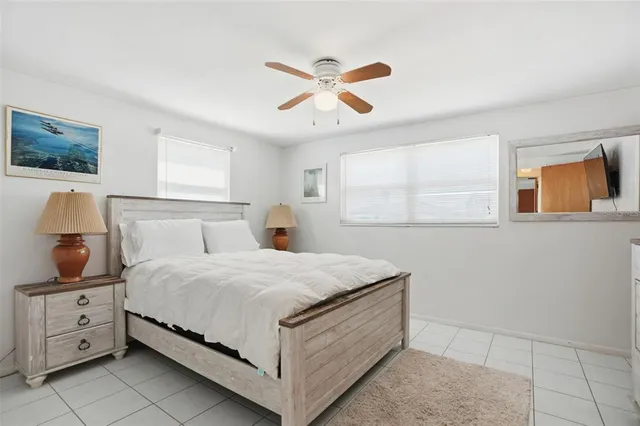 a bedroom with a bed and a television