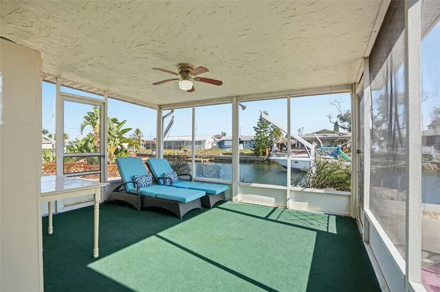 a living room with floor to ceiling windows and pool table