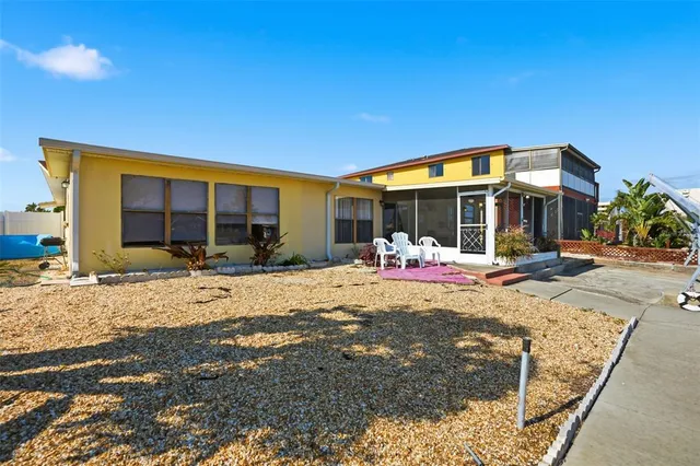 a view of a lake with boats and palm trees