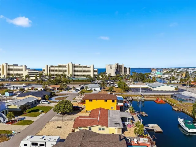 an aerial view of residential houses with outdoor space and swimming pool