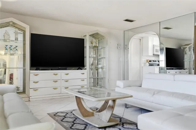 a living room with fireplace furniture and a flat screen tv