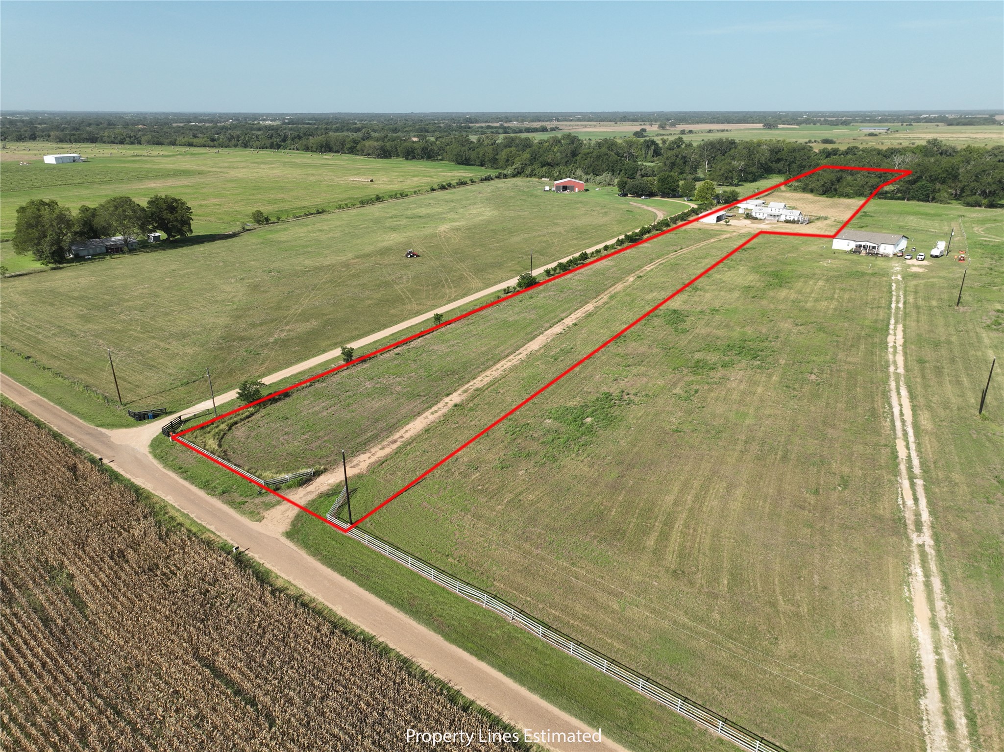 Acquire this sprawling acreage with multiple structures, offering vast potential for agricultural or private estate development.
