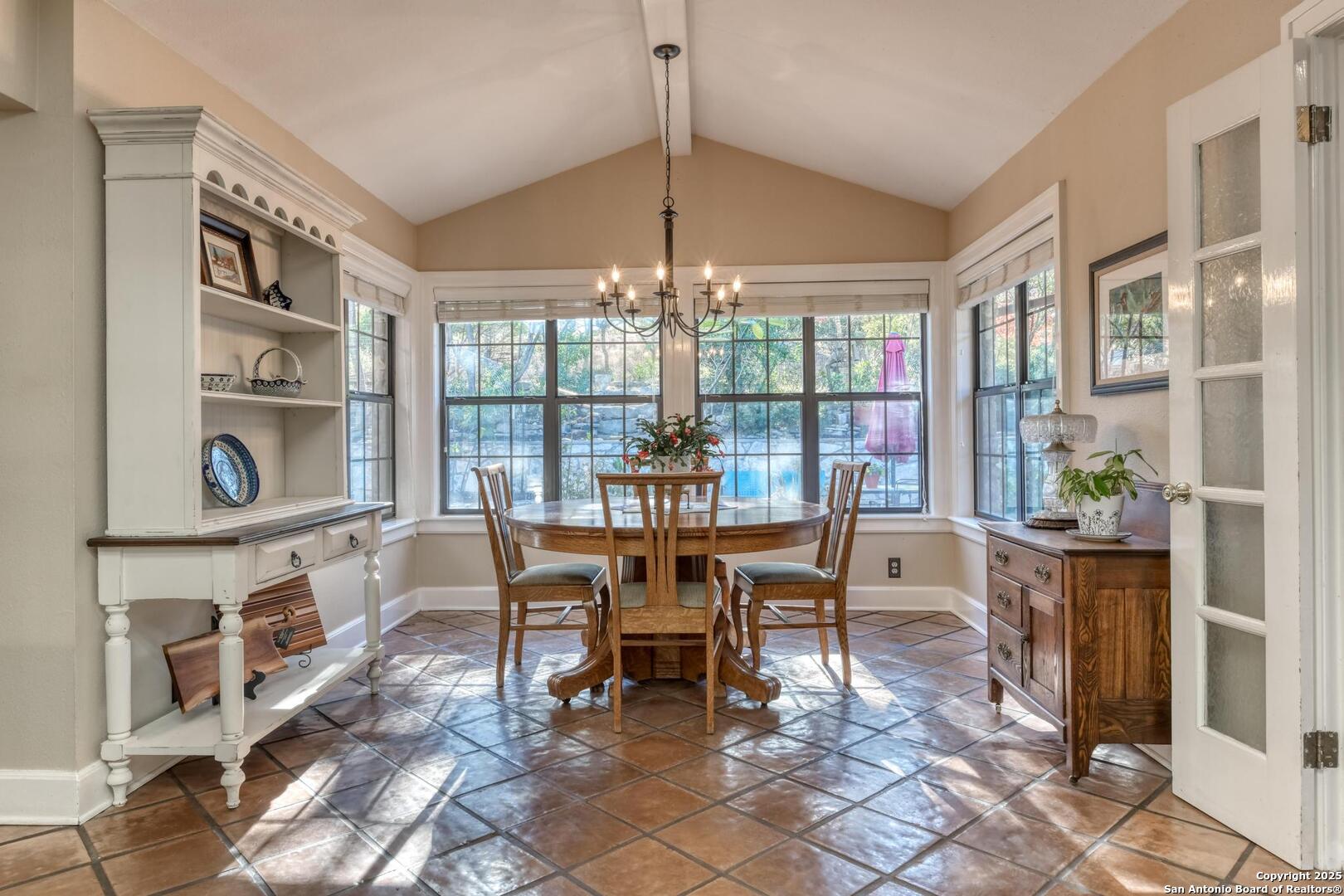 105 Shane Lane Boerne, TX 78006 - Photo 20 of 64 a dining room with furniture a rug and a chandelier