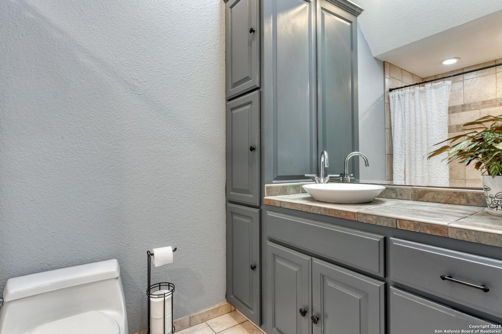 105 Shane Lane Boerne, TX 78006 - Photo 27 of 64 a bathroom with a granite countertop sink and a mirror