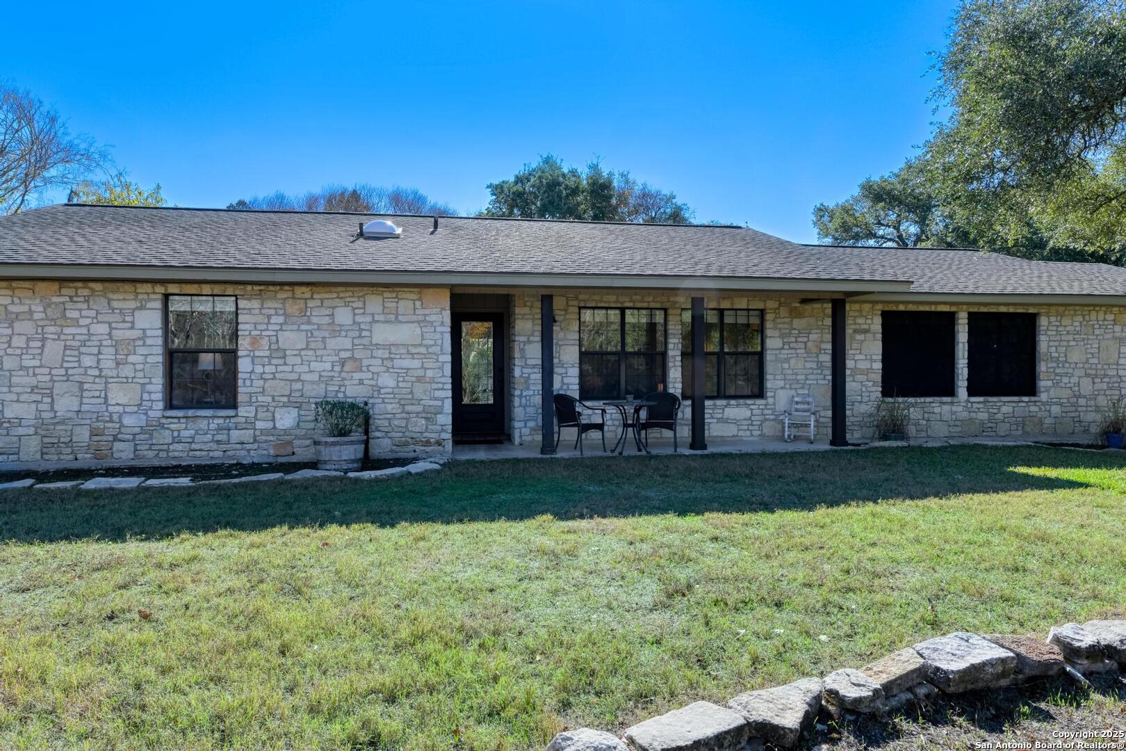 105 Shane Lane Boerne, TX 78006 - Photo 3 of 64 a view of a backyard with table and chairs and potted plants