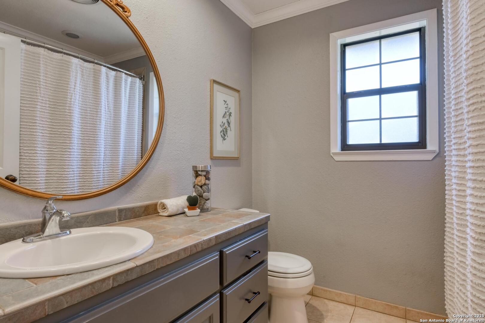 105 Shane Lane Boerne, TX 78006 - Photo 32 of 64 a bathroom with a granite countertop sink and a mirror