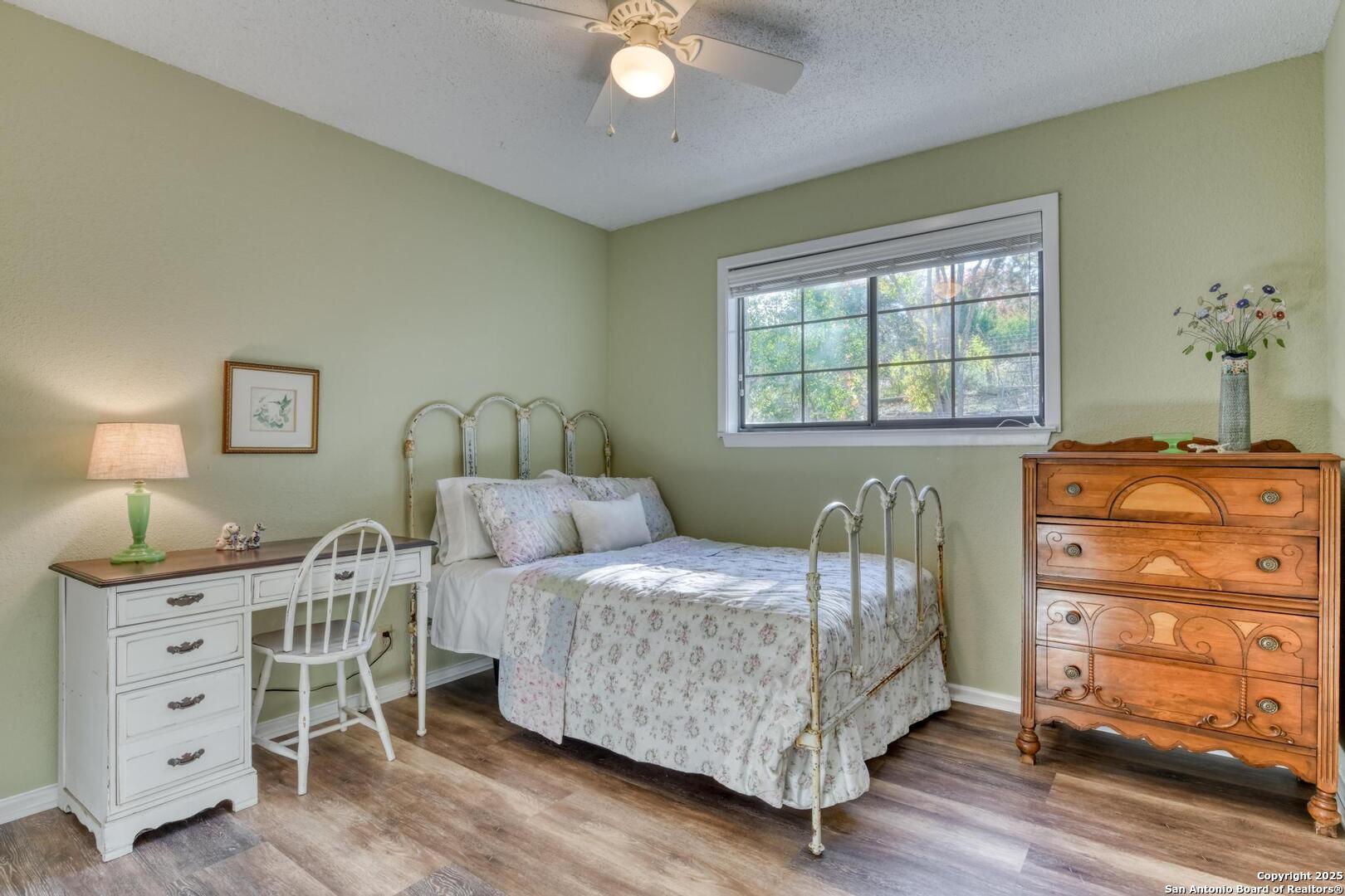 105 Shane Lane Boerne, TX 78006 - Photo 33 of 64 a bedroom with a bed and a dresser in it