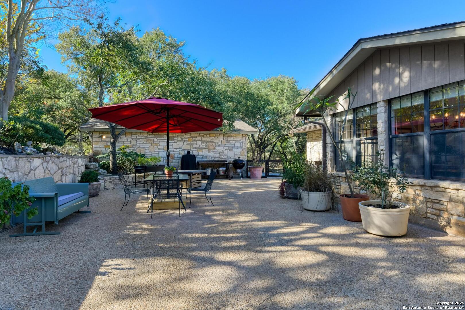 105 Shane Lane Boerne, TX 78006 - Photo 38 of 64 a view of a tables and chairs under an umbrella in patio