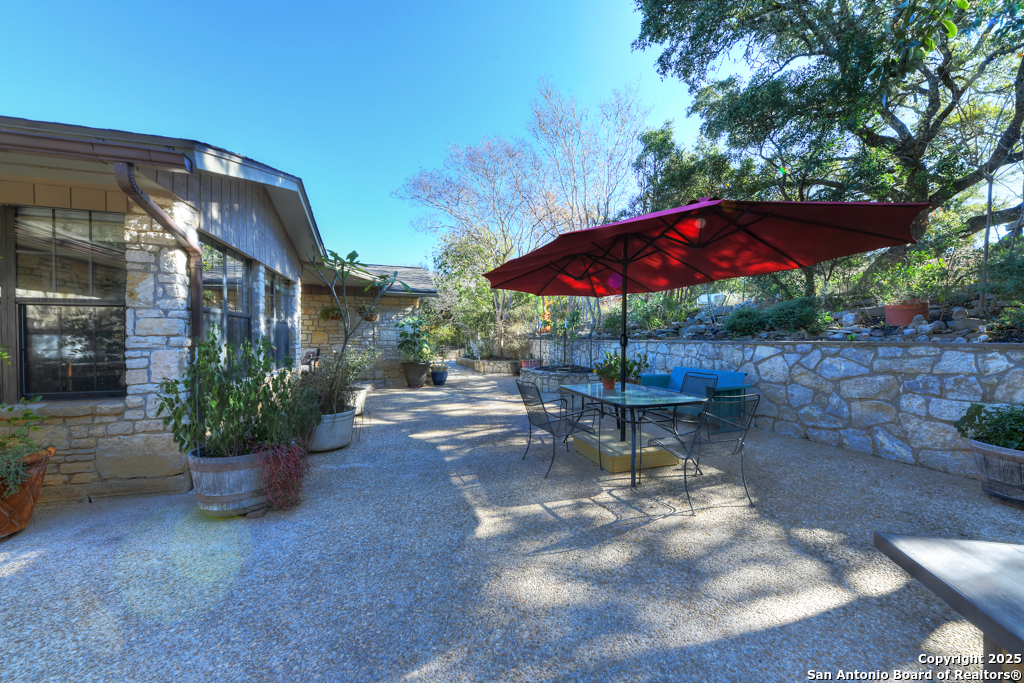 105 Shane Lane Boerne, TX 78006 - Photo 40 of 64 a view of a patio with a table and chairs under an umbrella