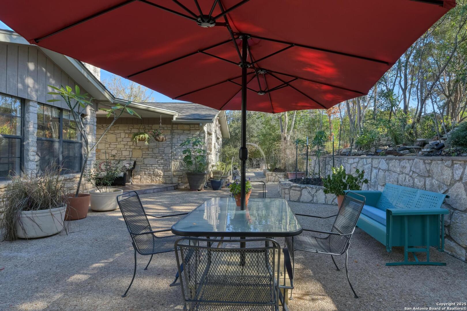 105 Shane Lane Boerne, TX 78006 - Photo 44 of 64 a view of a patio with a table and chairs under an umbrella