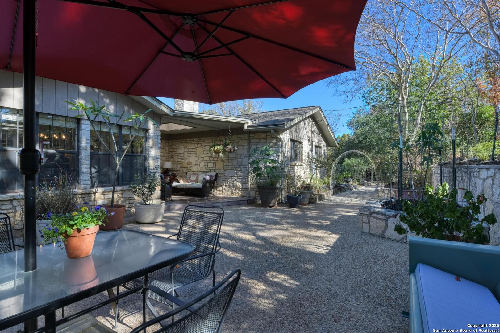 105 Shane Lane Boerne, TX 78006 - Photo 45 of 64 a patio with a table and chairs under an umbrella