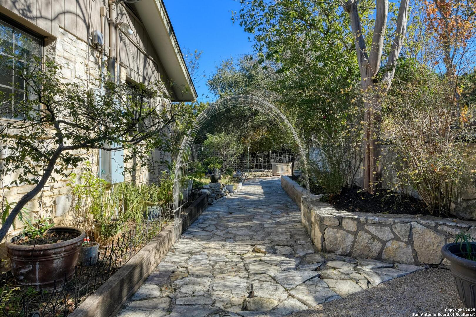 105 Shane Lane Boerne, TX 78006 - Photo 48 of 64 a view of a backyard with table and chairs