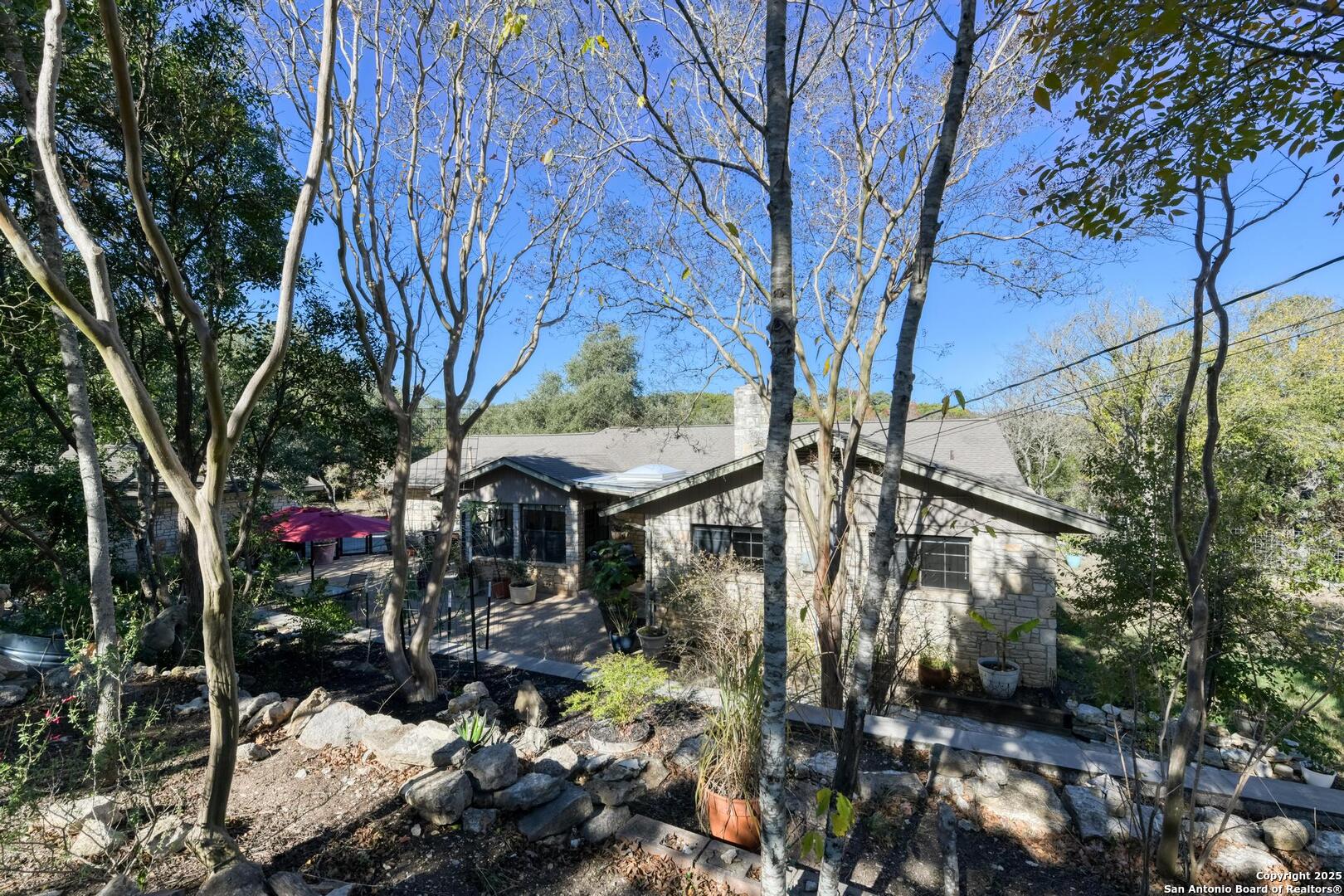 105 Shane Lane Boerne, TX 78006 - Photo 54 of 64 a view of a house with a tree in the forest
