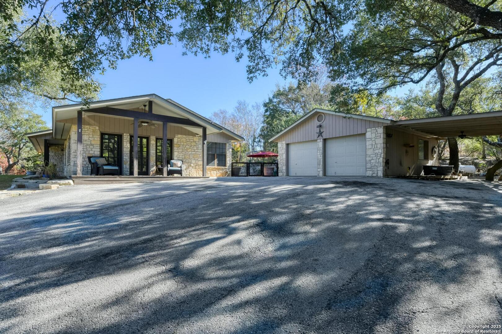 105 Shane Lane Boerne, TX 78006 - Photo 9 of 64 a front view of a house with a garden