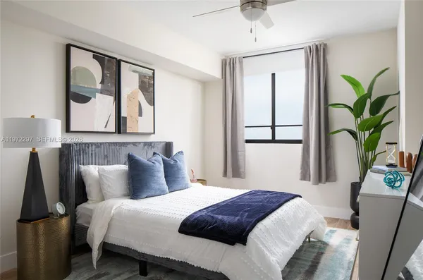 a bedroom with a bed and a large mirror